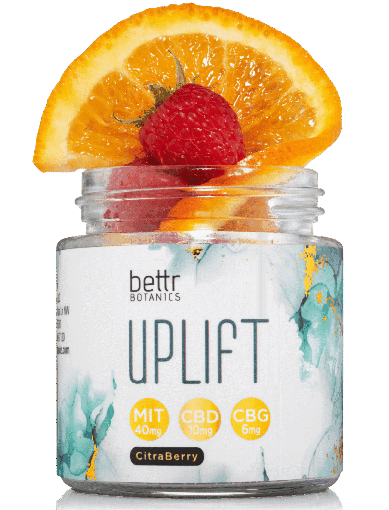 Uplift gummies jar with lid off showing oranges and raspberries for flavor